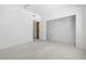 Comfortable bedroom, door, and adjacent closet with a wooden storage cabinet at 1830 N Buffalo Dr # 2014, Las Vegas, NV 89128