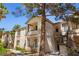 Multi-level condo building with balconies, stairs and mature trees at 1830 N Buffalo Dr # 2014, Las Vegas, NV 89128
