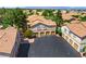 Exterior view of garage condos with red tile roofs, desert landscaping and nearby parking spaces at 1830 N Buffalo Dr # 2014, Las Vegas, NV 89128