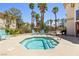 Community hot tub surrounded by palm trees, lounge chairs and condos at 1830 N Buffalo Dr # 2014, Las Vegas, NV 89128