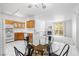 Inviting living space featuring a dining area, kitchen, and a cozy fireplace with access to an outdoor balcony at 1830 N Buffalo Dr # 2014, Las Vegas, NV 89128