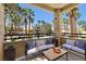 Inviting patio with comfortable seating overlooking the community pool and palm trees at 1830 N Buffalo Dr # 2014, Las Vegas, NV 89128