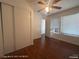 Bedroom featuring hardwood floors, closet with sliding doors, and bright windows at 1850 Camino Verde Ln, Las Vegas, NV 89119
