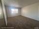 Neutral bedroom featuring a large window, closet with mirrored doors, and neutral carpet at 1850 Camino Verde Ln, Las Vegas, NV 89119