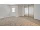 Neutral bedroom with carpet, closet with mirror doors, and a sliding glass door to the back at 1850 Camino Verde Ln, Las Vegas, NV 89119