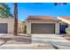 Charming single-story home featuring a brown garage door and a well-maintained, neutral-toned exterior at 1850 Camino Verde Ln, Las Vegas, NV 89119