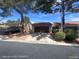 Home featuring a private entrance, attached garage, and desert landscaping on a sunny day at 1850 Camino Verde Ln, Las Vegas, NV 89119