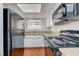 Functional kitchen featuring modern appliances, granite counters and a window for natural light at 1850 Camino Verde Ln, Las Vegas, NV 89119