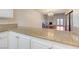 Beautiful kitchen with granite countertops overlooking an open-concept living area with wood flooring at 1850 Camino Verde Ln, Las Vegas, NV 89119