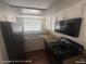 A clean kitchen featuring white cabinets, ample counter space, and a black appliance set at 1850 Camino Verde Ln, Las Vegas, NV 89119