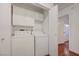 Convenient laundry room with washer, dryer, and storage cabinets at 1850 Camino Verde Ln, Las Vegas, NV 89119