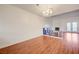 Bright and airy living room with wood floors, a cozy fireplace, and stylish chandelier at 1850 Camino Verde Ln, Las Vegas, NV 89119