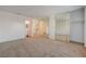 Spacious main bedroom with ensuite bathroom, large closet, and neutral carpeting at 1850 Camino Verde Ln, Las Vegas, NV 89119