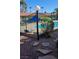 Community pool area with sunshades and lounge chairs, enclosed by iron fencing at 1850 Camino Verde Ln, Las Vegas, NV 89119