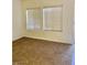 Bedroom with neutral carpet, two windows and blinds at 2121 Hussium Hills St # 107, Las Vegas, NV 89108