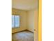 Neutral bedroom featuring carpeted floors, bright natural light from the window, and a door to the hallway at 2121 Hussium Hills St # 107, Las Vegas, NV 89108
