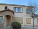 Charming townhome features stucco exterior, tiled roof, and desert landscaping at 2121 Hussium Hills St # 107, Las Vegas, NV 89108