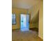 Living room view featuring carpeted floors, a window, the front door and a closet at 2121 Hussium Hills St # 107, Las Vegas, NV 89108