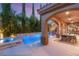 Inviting backyard with covered patio, pool, hot tub, and lush landscaping at 2240 Boutique Ave, Henderson, NV 89044
