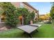 Spacious backyard with ping pong table, lush lawn, and mature trees, ideal for recreation at 2240 Boutique Ave, Henderson, NV 89044