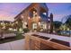 Outdoor kitchen with a seating area on a meticulously landscaped lawn in this beautiful backyard at 2240 Boutique Ave, Henderson, NV 89044