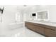 Modern bathroom with dual vanities, a freestanding tub, and elegant marble flooring at 2240 Boutique Ave, Henderson, NV 89044
