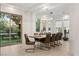 Bright dining room featuring modern light fixture, large windows, and sliding door to backyard at 2240 Boutique Ave, Henderson, NV 89044
