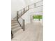 Bright, open entryway showcasing modern staircase design and tile flooring, leading to a pool view at 2240 Boutique Ave, Henderson, NV 89044