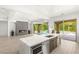 Stylish kitchen open to the living room, with views to the pool and outdoor living space at 2240 Boutique Ave, Henderson, NV 89044