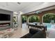 Cozy living room featuring a fireplace, TV, and outdoor dining beside the sparkling pool at 2240 Boutique Ave, Henderson, NV 89044