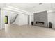 Open living room features a sleek fireplace, modern staircase, and bright, natural light at 2240 Boutique Ave, Henderson, NV 89044