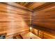 Inviting sauna with wood paneled walls and ceiling and tiered wooden benches at 2240 Boutique Ave, Henderson, NV 89044
