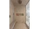 Walk-in shower featuring a built-in bench and tiled walls at 2240 Boutique Ave, Henderson, NV 89044