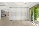 Modern wine storage with glass doors next to large windows and lush greenery outside at 2240 Boutique Ave, Henderson, NV 89044