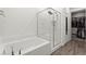 Bright bathroom featuring a tub, glass enclosed shower, and access to a walk-in closet at 25 Barbara Ln # 36, Las Vegas, NV 89183