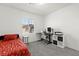 Bright bedroom with a bed, desk, and window offering natural light at 25 Barbara Ln # 36, Las Vegas, NV 89183
