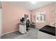 Comfortable bedroom with pink walls, a desk setup, and natural light from the window at 25 Barbara Ln # 36, Las Vegas, NV 89183