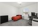 Simple bedroom with a black cabinet, red bedspread, and a workspace at 25 Barbara Ln # 36, Las Vegas, NV 89183