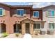 Charming two-story townhouse featuring a stone-accented entrance and a well-maintained, xeriscaped front yard at 25 Barbara Ln # 36, Las Vegas, NV 89183