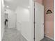 Well-lit hallway showcasing an open doorway and a charming 