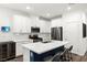 Modern kitchen featuring stainless steel appliances, white cabinets, quartz countertops, and a kitchen island with seating at 25 Barbara Ln # 36, Las Vegas, NV 89183