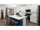 Bright kitchen showcasing a quartz countertop island, stainless steel appliances, and modern lighting at 25 Barbara Ln # 36, Las Vegas, NV 89183