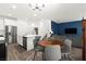 Open-concept living area featuring modern kitchen, dining space, and comfortable lounge with hardwood floors at 25 Barbara Ln # 36, Las Vegas, NV 89183