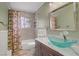 Bathroom featuring a glass bowl sink, decorative shower curtain, and tile surround at 2706 Colanthe Ave, Las Vegas, NV 89102