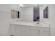 Bathroom featuring double vanity with white cabinets, a large mirror and bright lighting at 2706 Colanthe Ave, Las Vegas, NV 89102