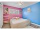 Bedroom with pink and blue walls, window with shutters, and light-colored carpet at 2706 Colanthe Ave, Las Vegas, NV 89102