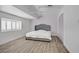 Bright bedroom with a plush bed, shuttered windows, and wood-look flooring at 2706 Colanthe Ave, Las Vegas, NV 89102