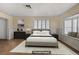 Bedroom features neutral walls, shuttered windows, and an area rug over tile flooring at 2706 Colanthe Ave, Las Vegas, NV 89102