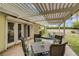 Cozy covered patio featuring a dining set, perfect for outdoor entertaining and relaxation in a backyard setting at 2706 Colanthe Ave, Las Vegas, NV 89102
