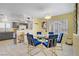 Bright dining room with a glass table and blue velvet chairs adjacent to the kitchen at 2706 Colanthe Ave, Las Vegas, NV 89102